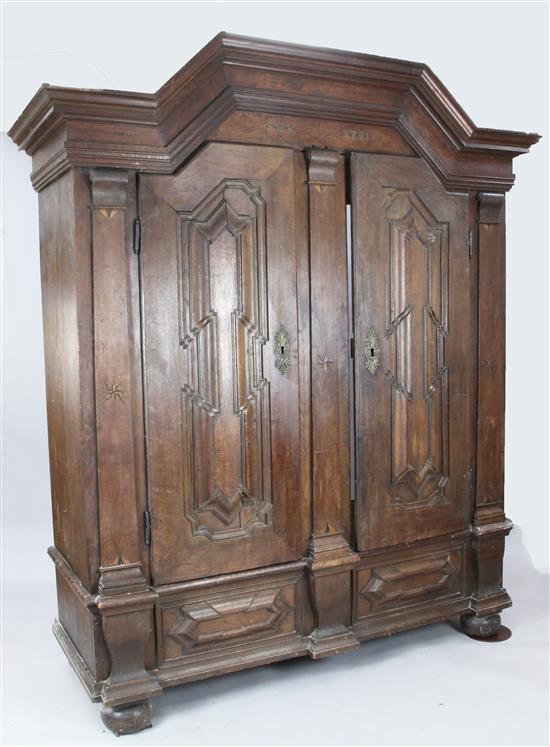 An 18th century inlaid Dutch carved oak schrank, W. 6ft 5in. D. 2ft 4in. H. 7ft 7in.